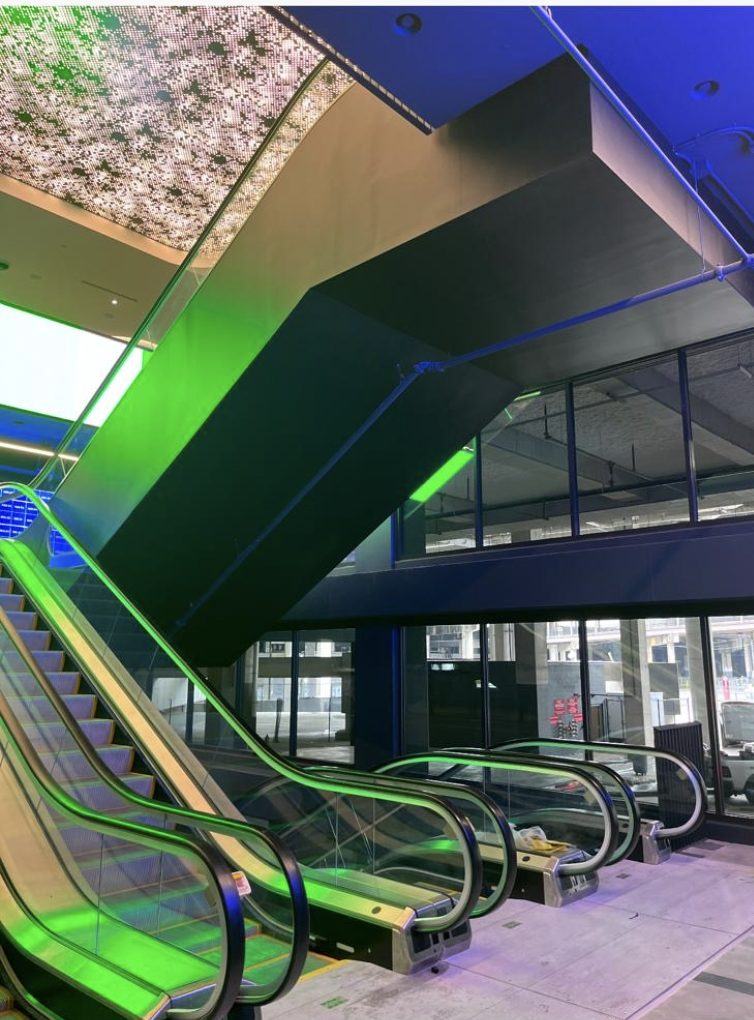Escalator soffit and cladding in wood-look film