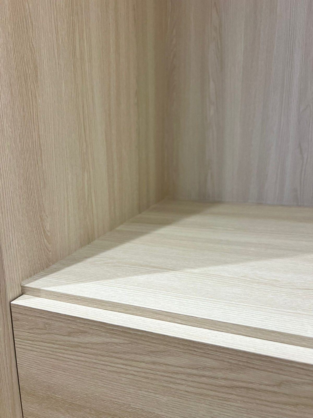 Close-up of light wood-look film on shelving