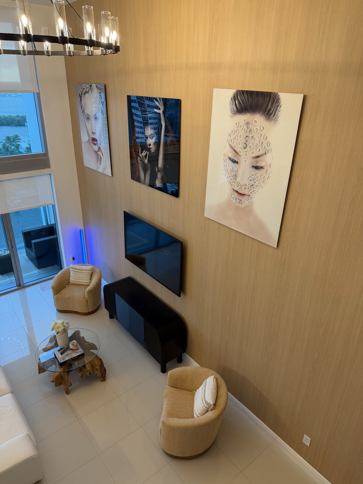Double-height living room with a light wood-look feature wall