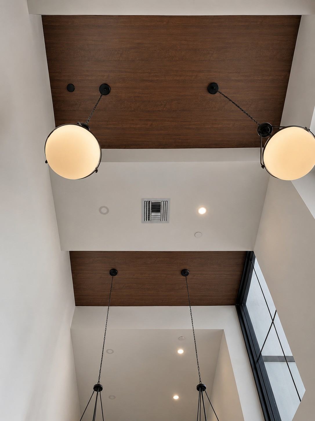 Ceiling with wood-look panels and pendant lights