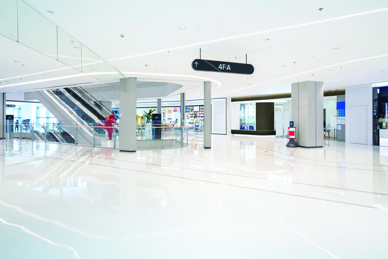 Bright atrium with white stone-look surfaces