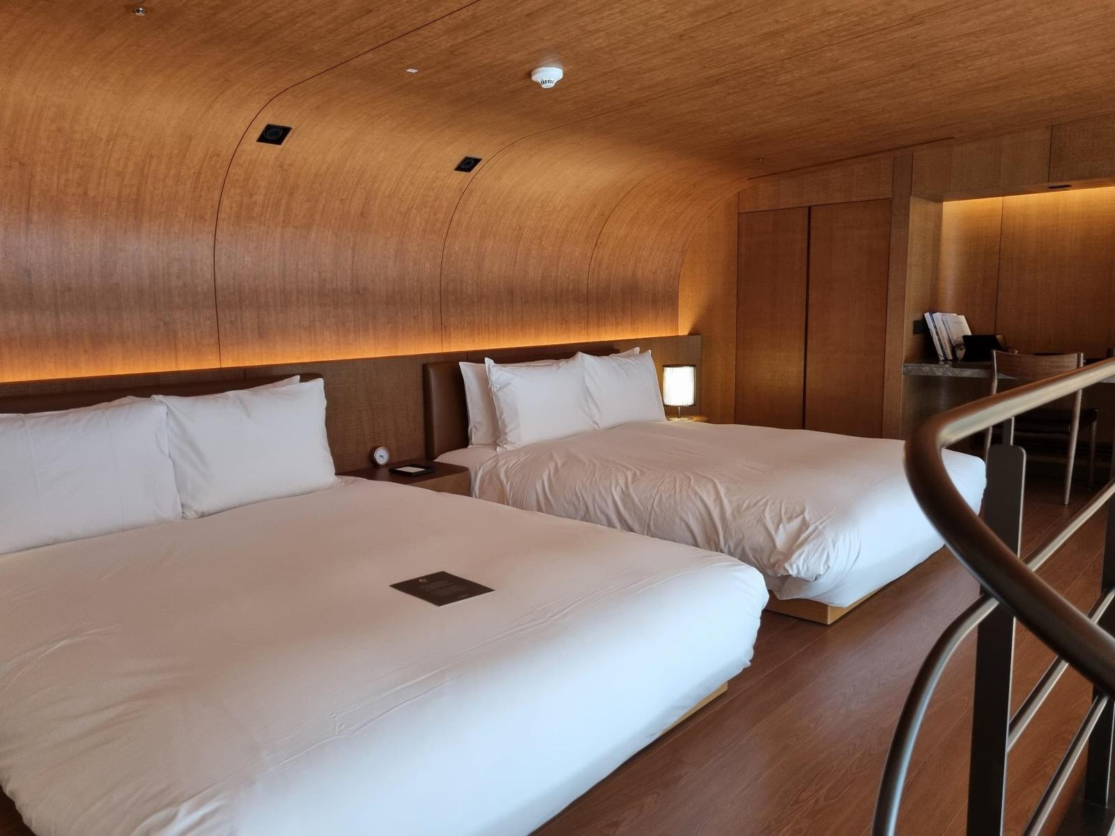 Hotel room with curved wood-look ceiling and walls